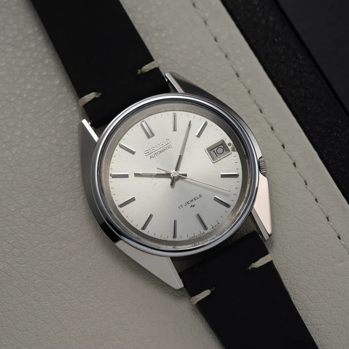 1979 Seiko 7025-8120 with silver sunburst dial, single date window and black leather strap
