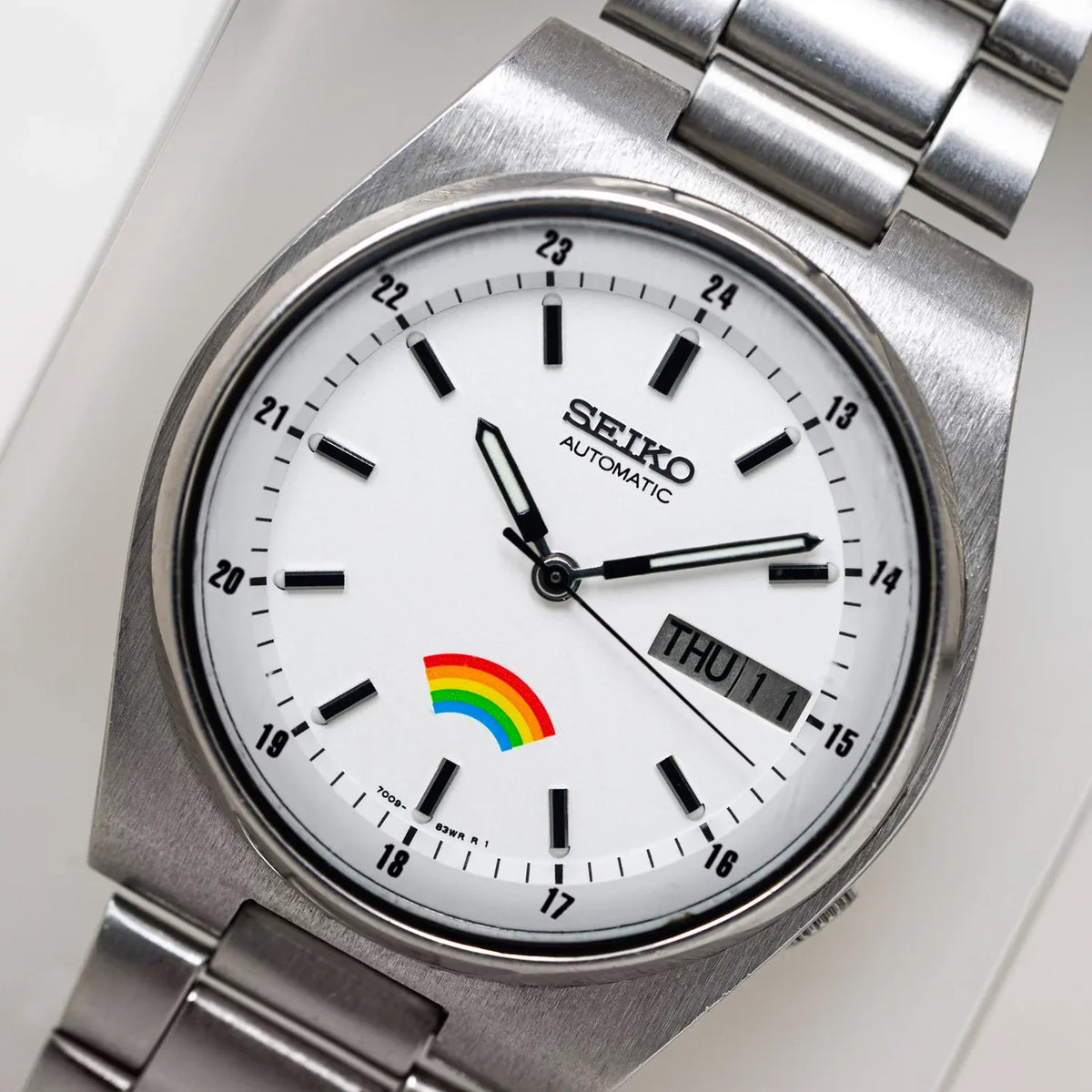 Vintage Seiko Rainbow 7009-316A from 1982 with a white dial, printed colour arc and integrated steel bracelet, VWS photograph