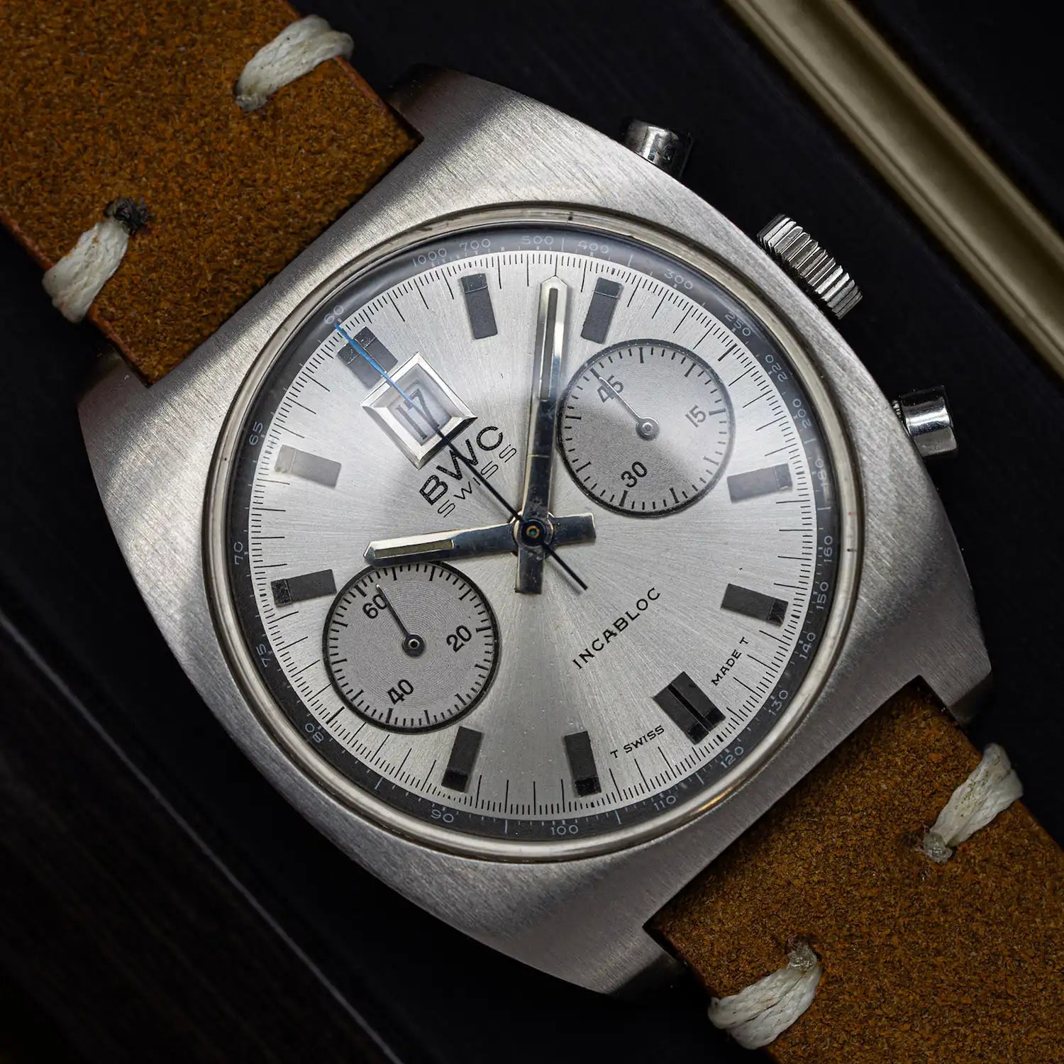 Chronograph vintage watch with silver dial on black background