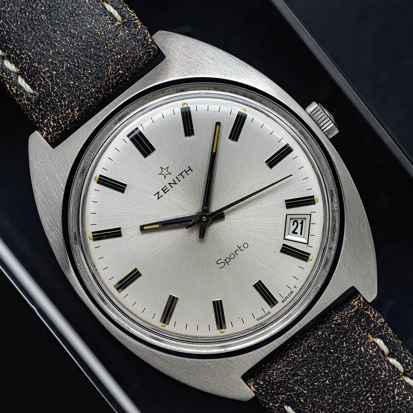 Zenith Sporto vintage watch with silver dial and brown leather strap on black background