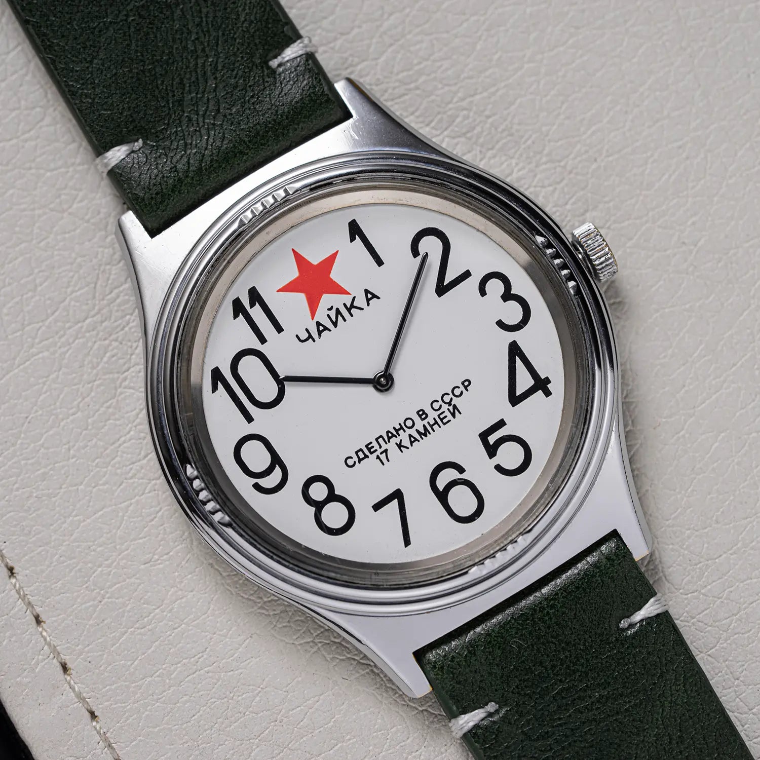 Caika Big Numerals vintage watch on white leather background