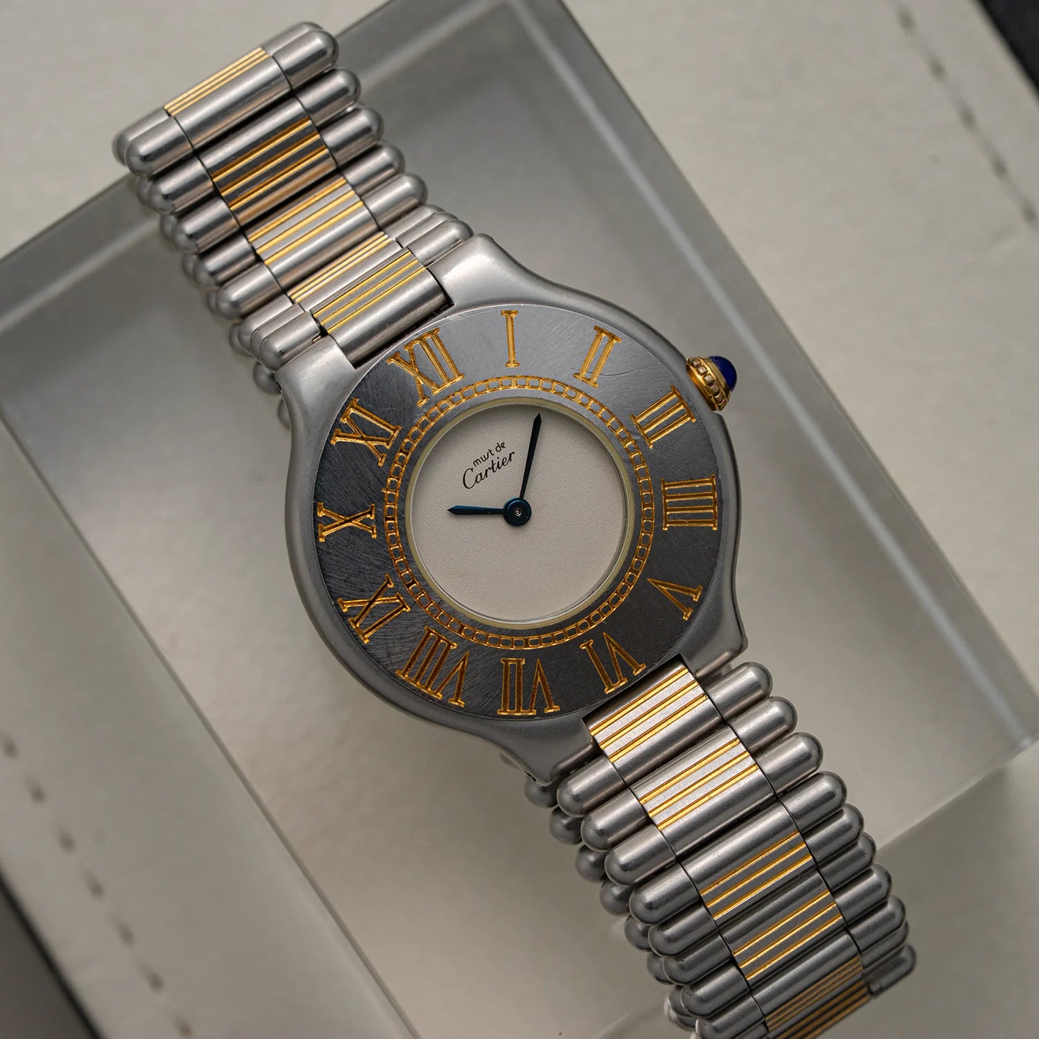 Luxury Cartier Must De Cartier 21, Ref. 9010, Cal. 81, 1989 watch with silver and gold band on a light gray background