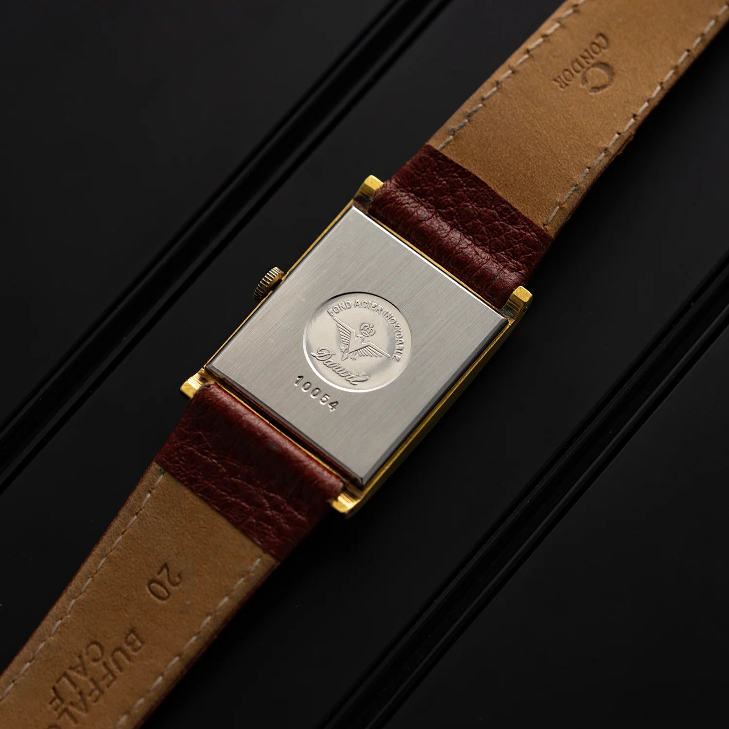 Caseback of Darwil Special Flat vintage watch with engraved Darwil medallion and brown leather strap