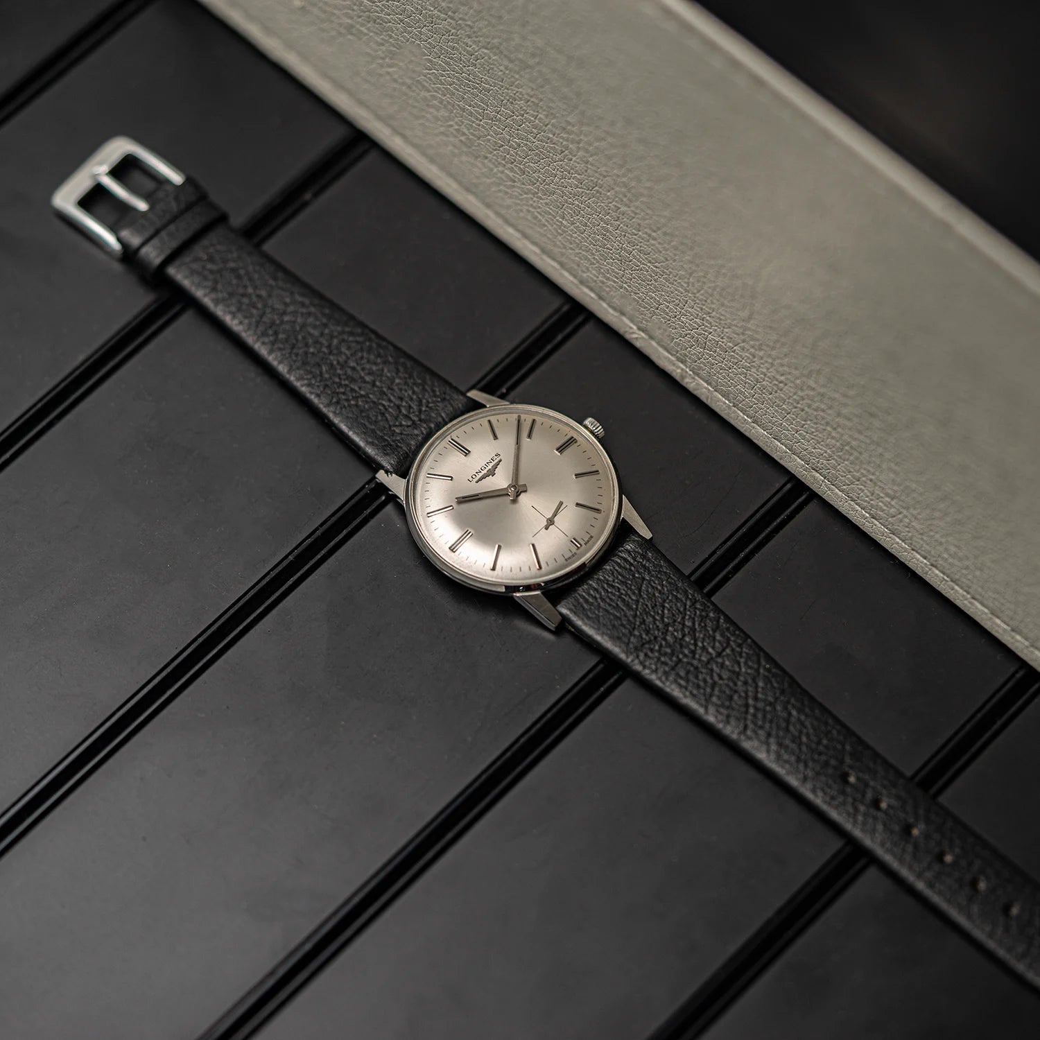 Wristwatch Longines, Ref. 1016, Cal. 6922, Men’s Dress Watch, 1969 with black leather strap on a textured surface