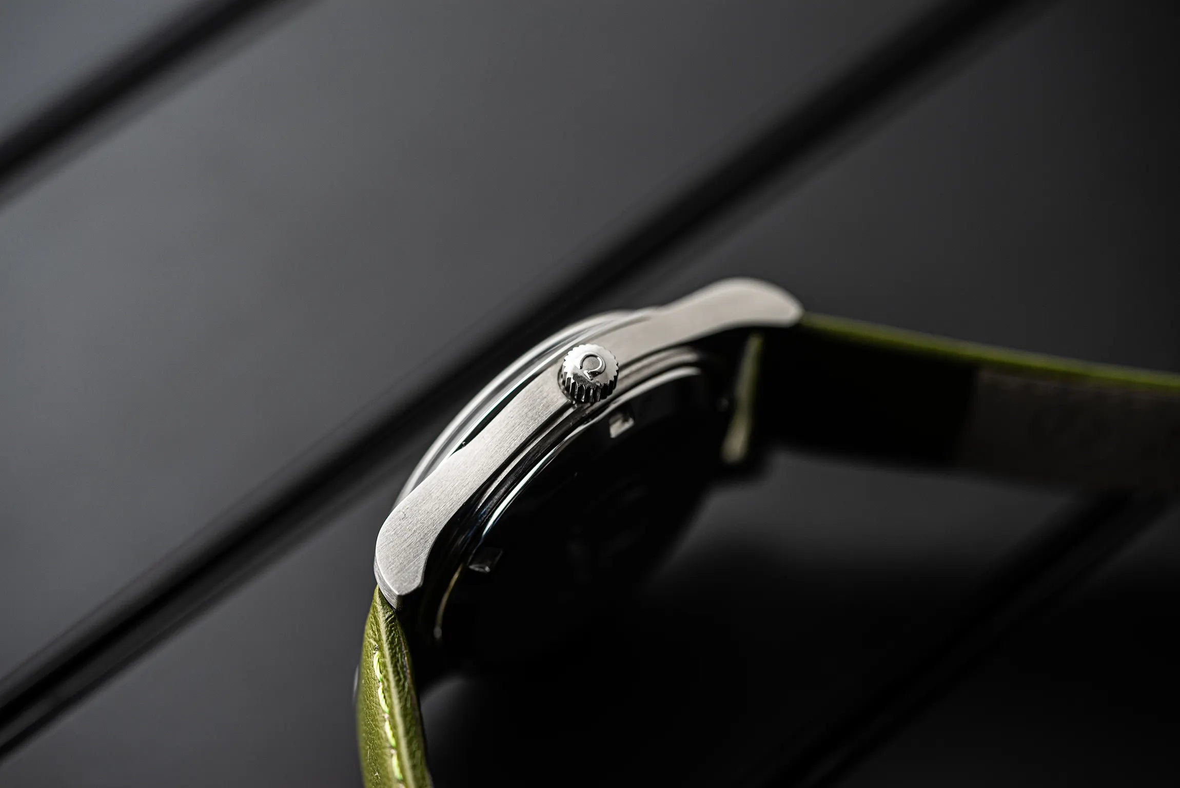 Close-up of a Omega Genève, Ref. 166.0168, Cal. 1012 Crown on a dark background