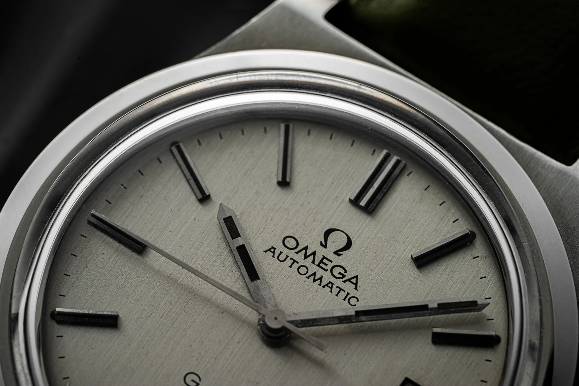 Close-up of an Omega Genève, Ref. 166.0168, Cal. 1012 watch face with metallic casing
