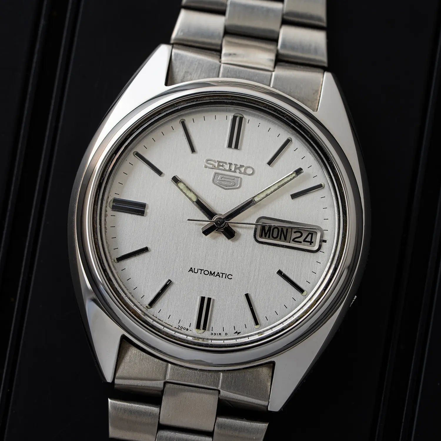Seiko 5, Ref. 7009-8741 watch with a white face on a black background