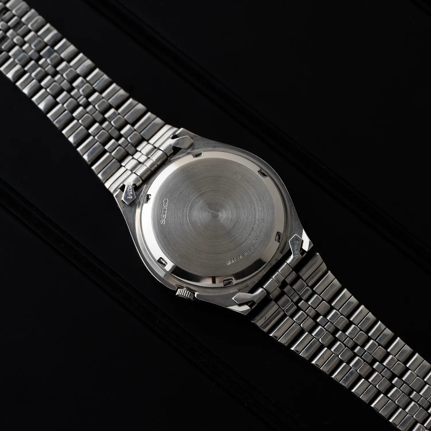 Seiko 5 7S26 3170 caseback on a black background