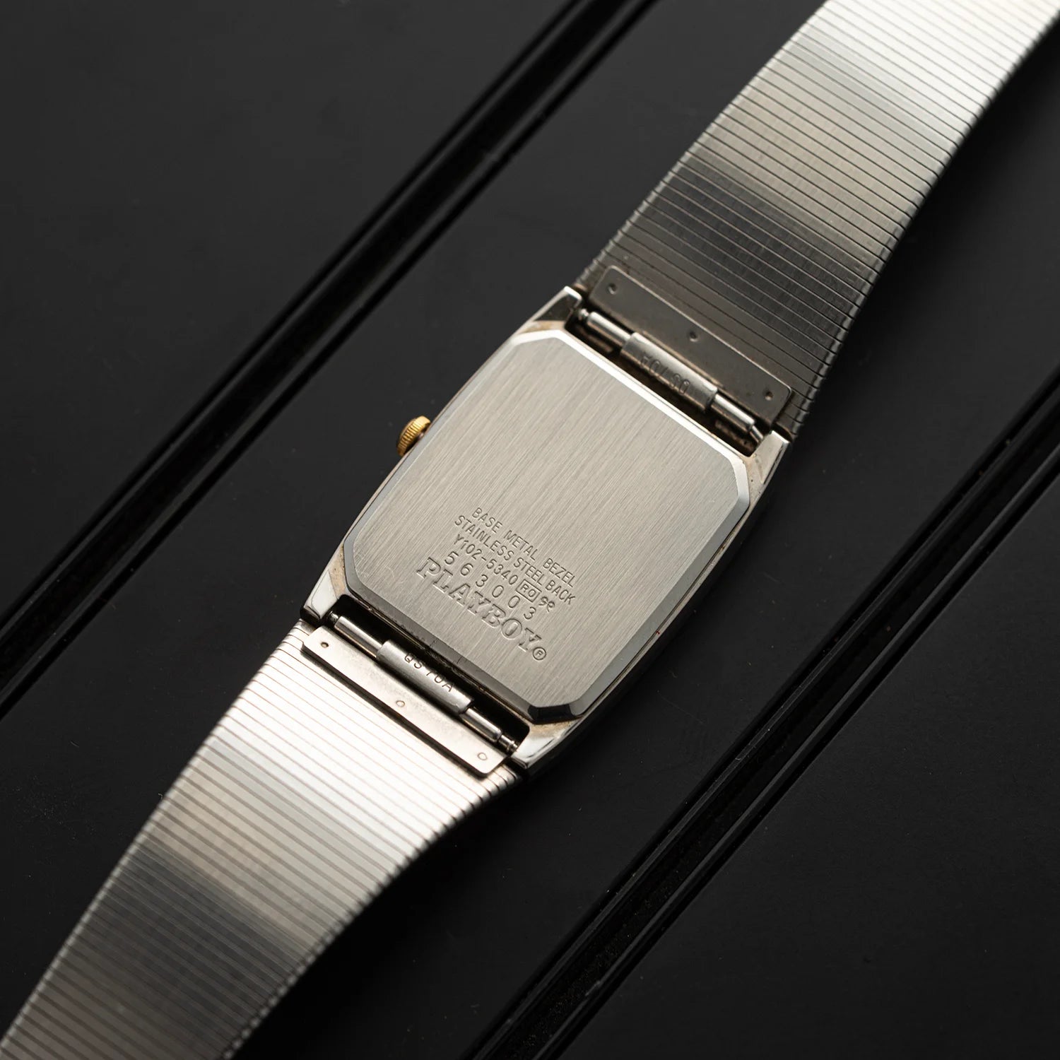 Caseback of Seiko Playboy vintage quartz watch with integrated metal bracelet and engraved rear details
