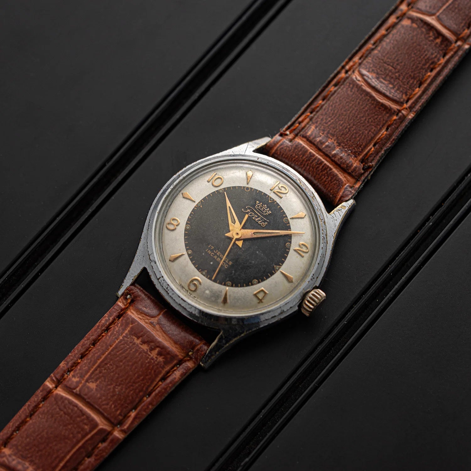 Vintage watch Fortis, Ref. 2127, Cal. ETA 1080, Men’s Manual Wind, 1958 with brown leather strap on a black background