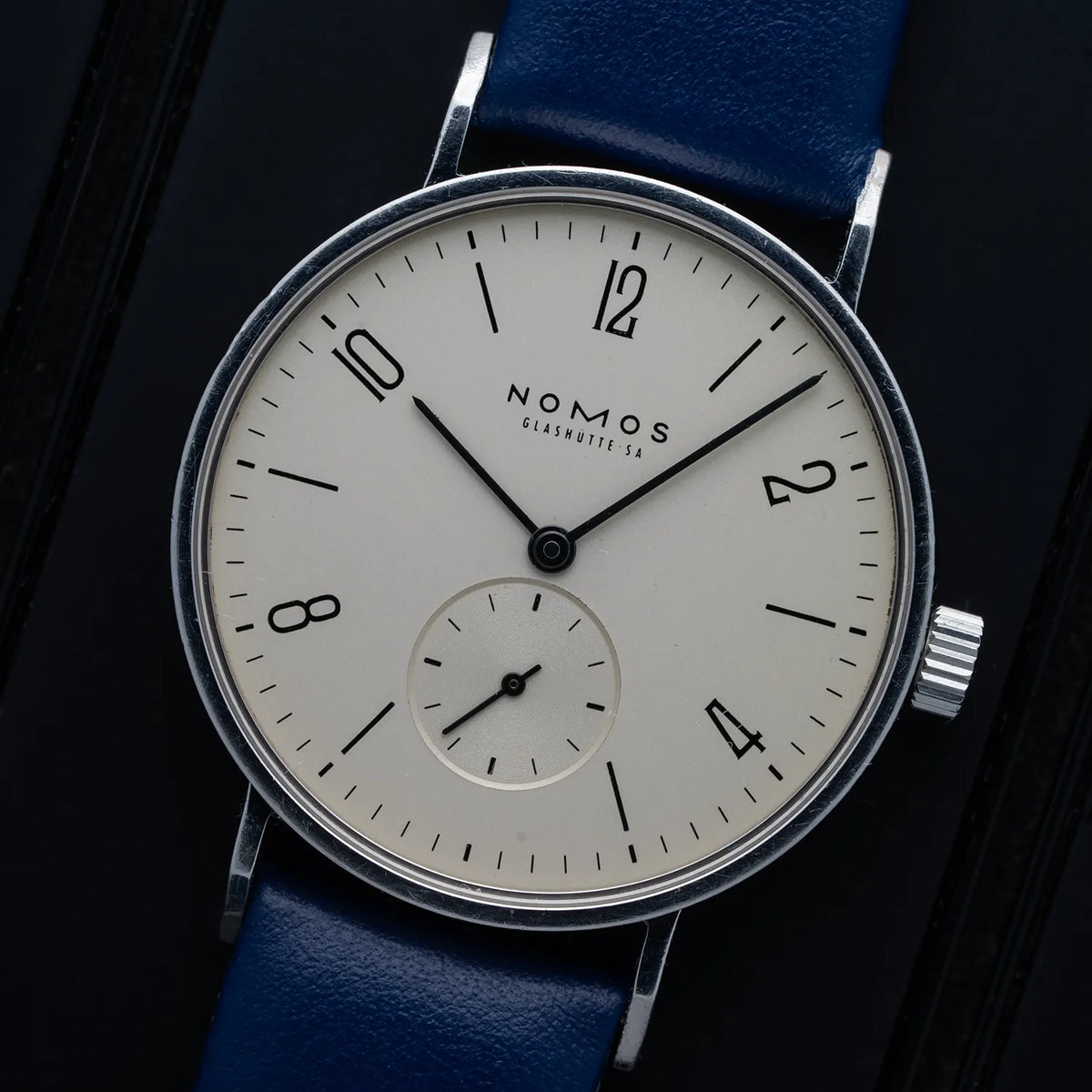 Nomos Tangente 101 watch with blue strap on a dark background