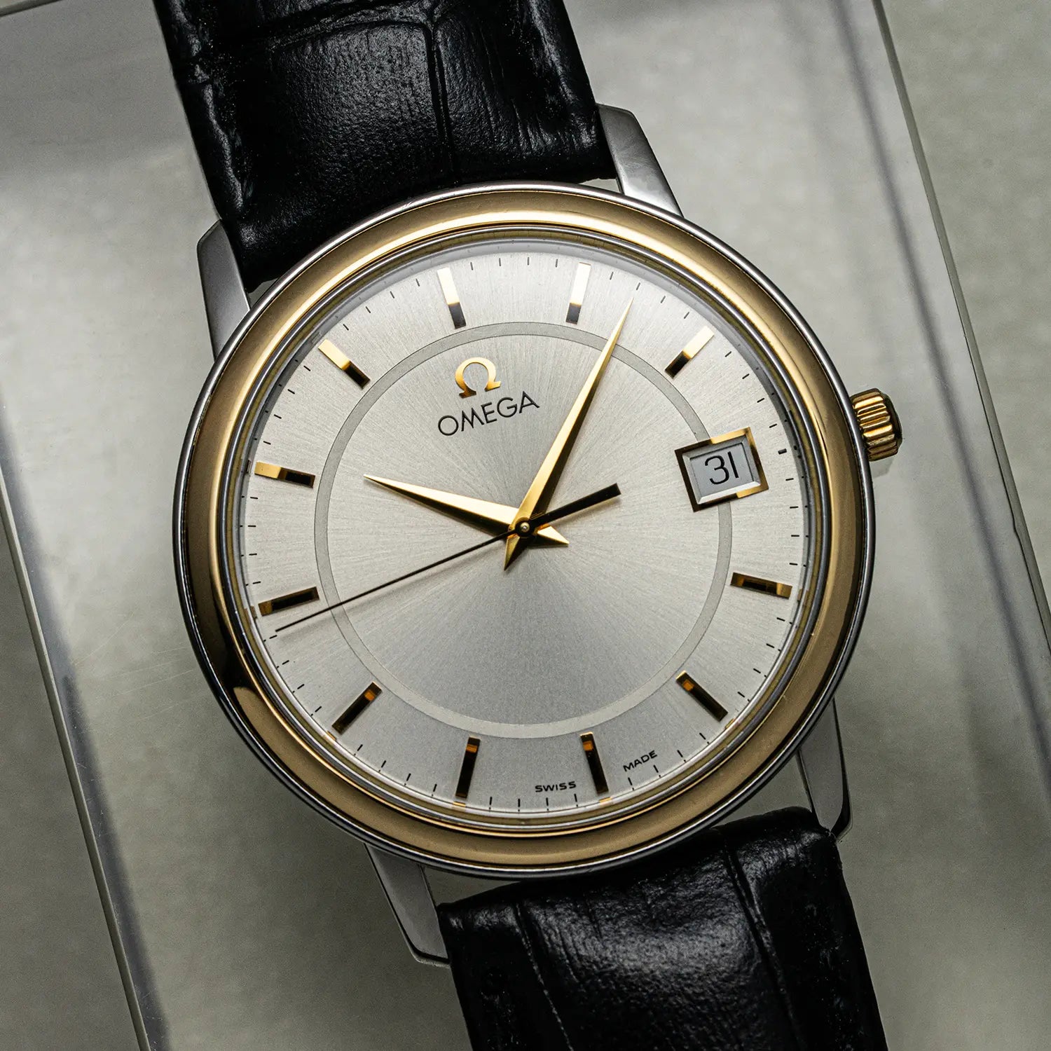 Omega De Ville Prestige, Ref. 196.1150 watch with black leather strap on a metallic surface
