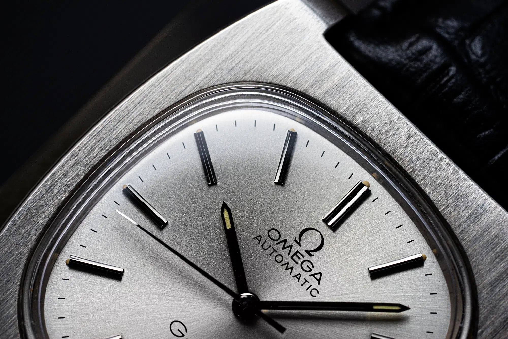 Close-up of a Vintage Omega Geneve watch with Reference 166.0190 and 1012 Caliber face with sunburst silver color finish
