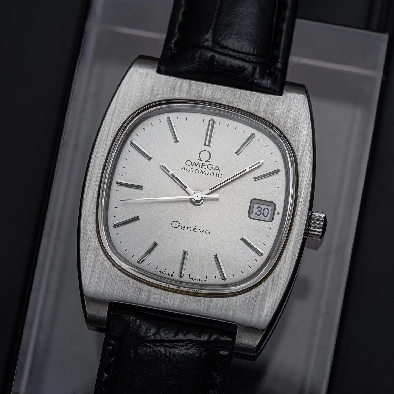 Vintage Omega Geneve watch with Reference 166.0190 and 1012 Caliber with black leather strap on a dark background