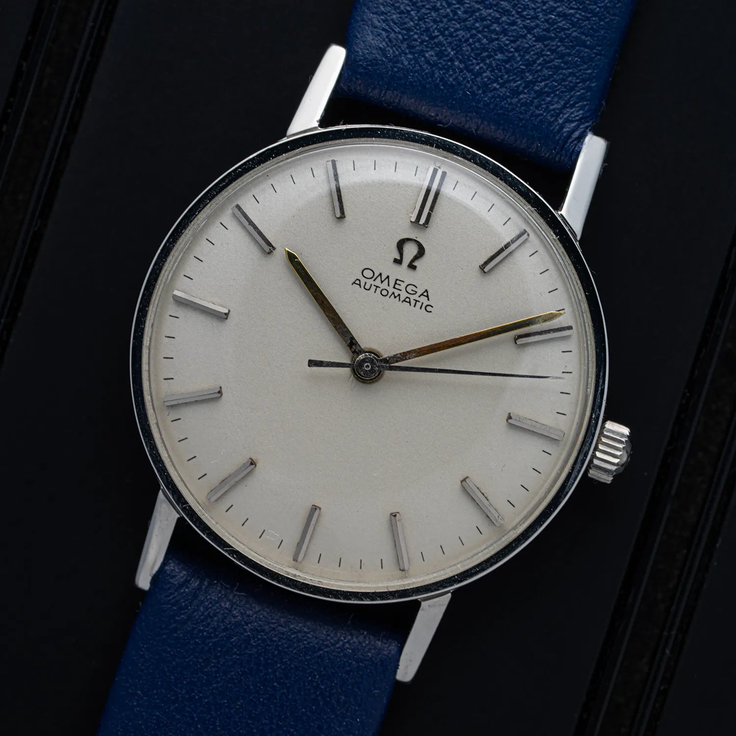 Omega, Ref. 14786SC, Cal. 552 watch with a blue strap on a dark background