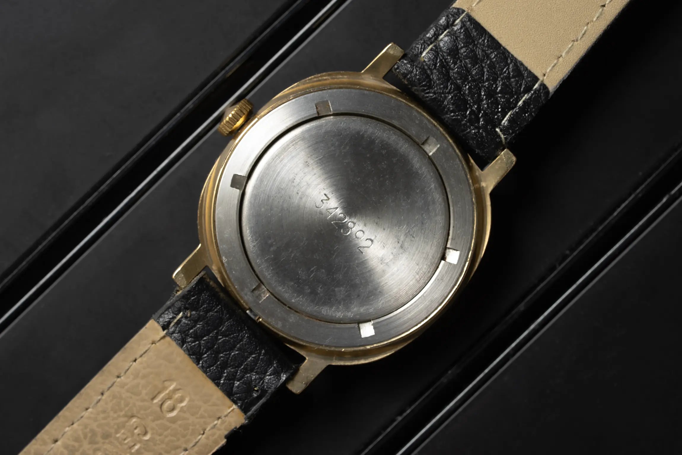 Poljot Square caseback on black background