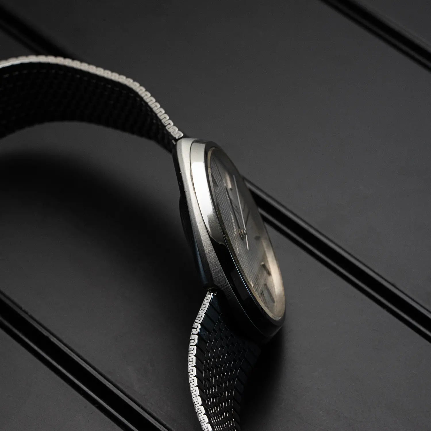 Close-up of Seiko Quartz 4100-9029 watch case on a black background