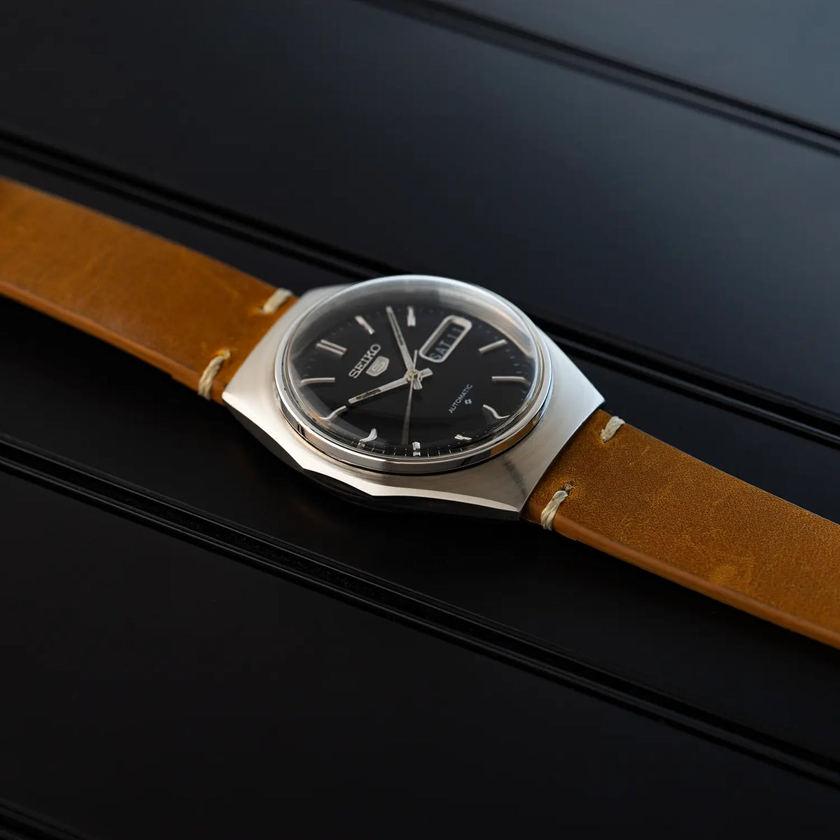 Vintage watch Seiko 5 6309 8840 case with brown leather strap on a black background