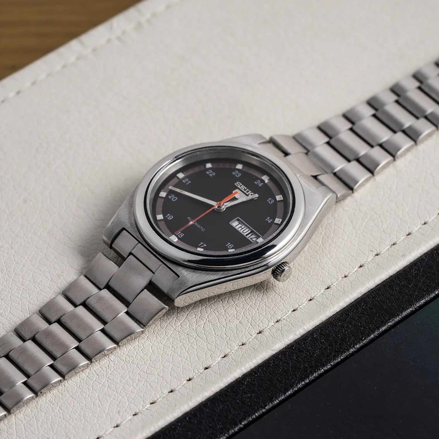 Seiko 5 6309 8980 crown with a black face on a white surface