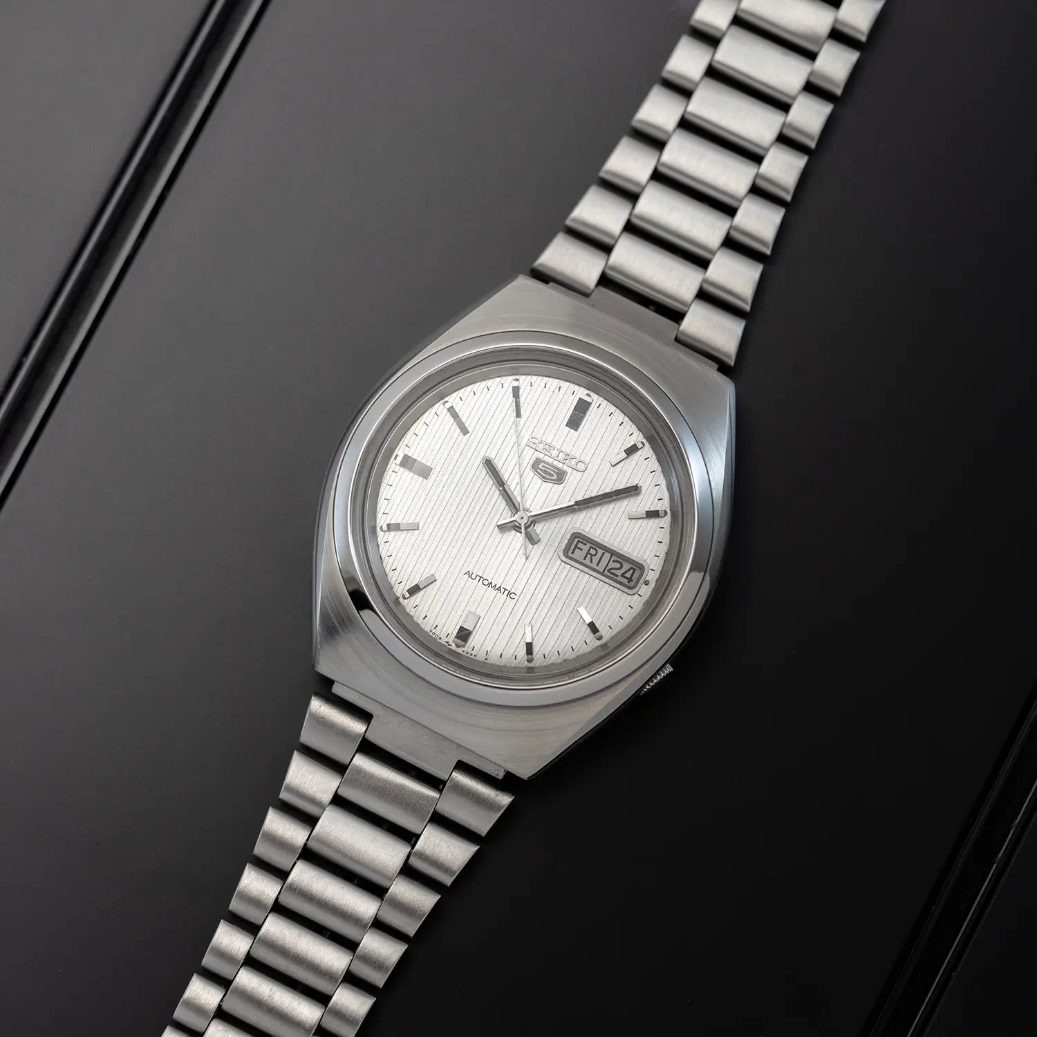 Seiko 5 7009 8431 with a white face on a black background