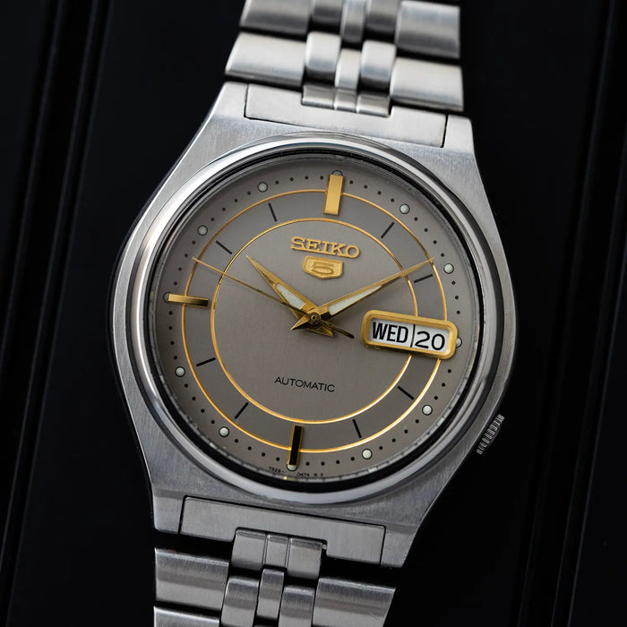 Seiko 5 7S26 3170 watch with a gray face on a black background