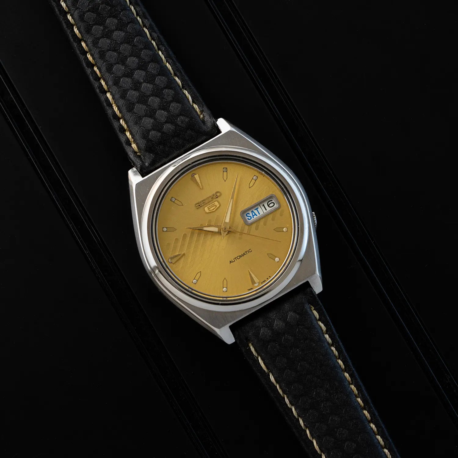 Seiko 5, 7S26-8760, yellow dial and black strap on a black background