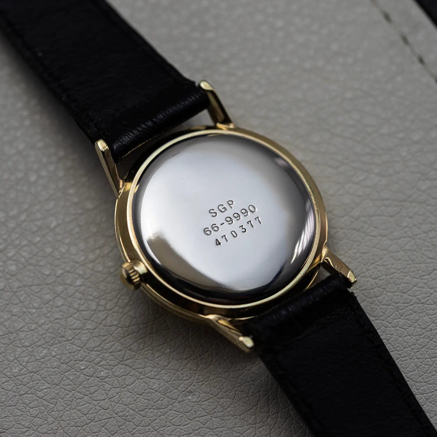 Backcase of Seiko 66 9990 on leather background
