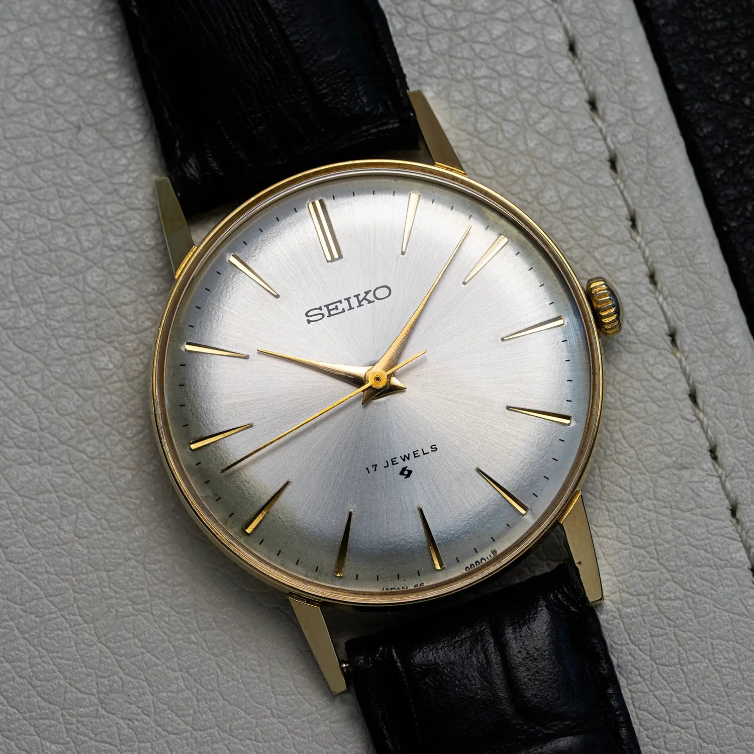 Seiko 66 9990 watch with black leather strap on a textured surface