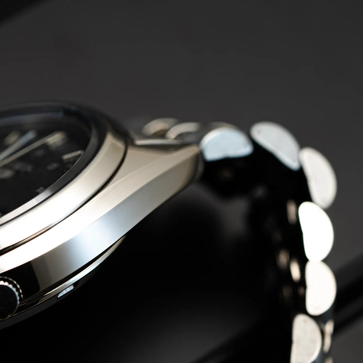 Close-up of a Seiko 5 7009 3040 with metallic accents on a dark background