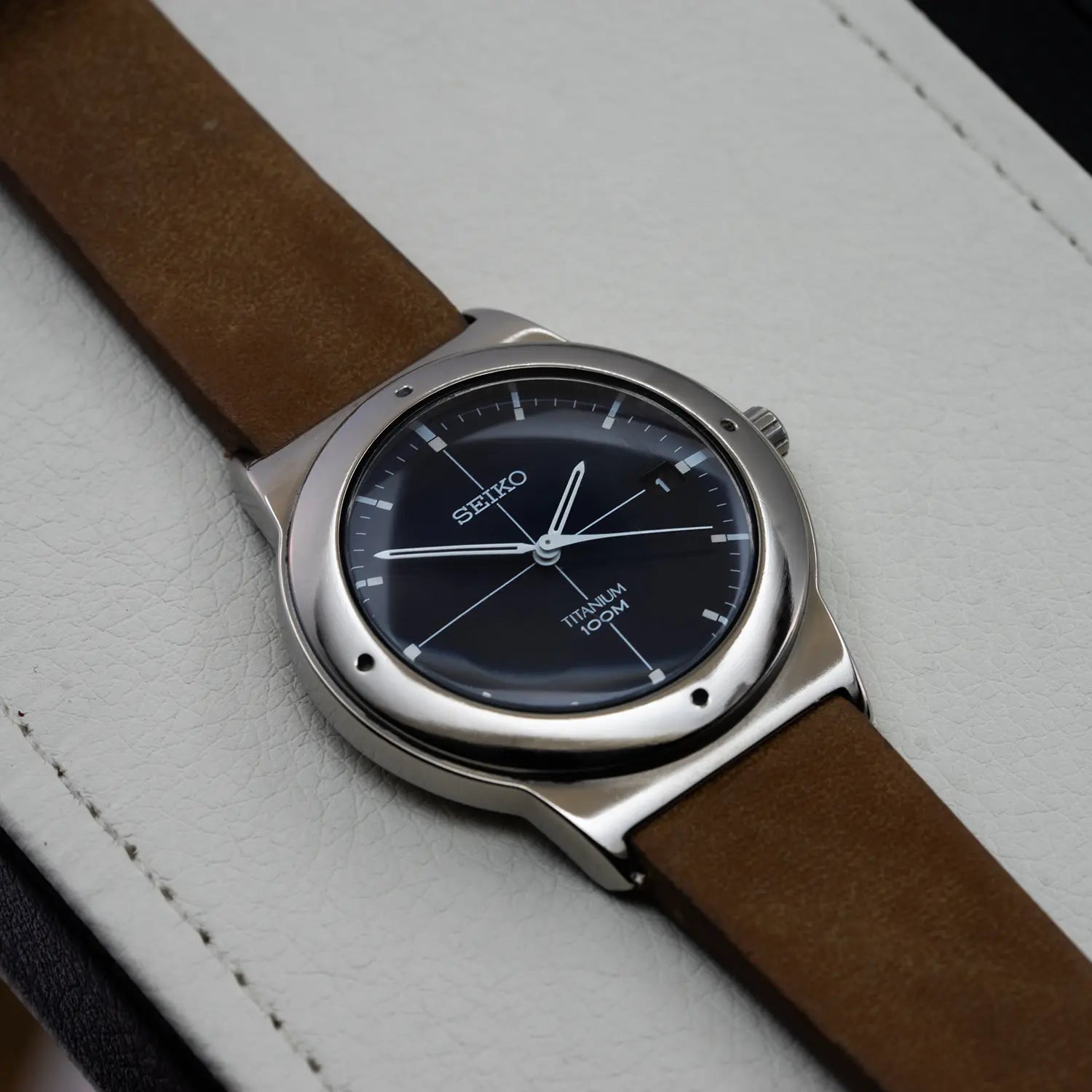 Seiko 7N42-0CB0 case with brown leather strap on a light gray background