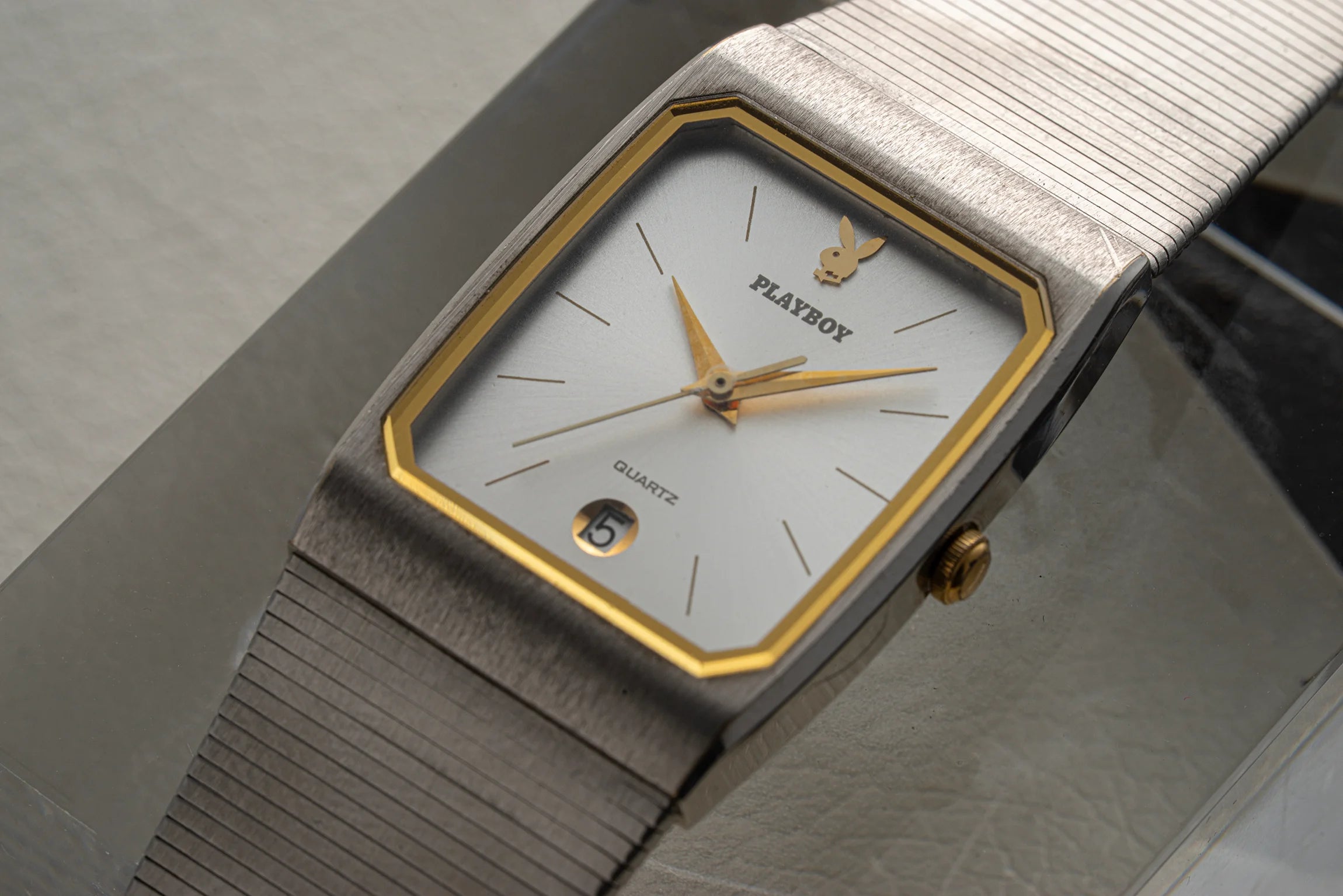 Close-up of Seiko Playboy dial with silver sunburst finish, gold-tone hands, rabbit logo, and date window at 6 o’clock