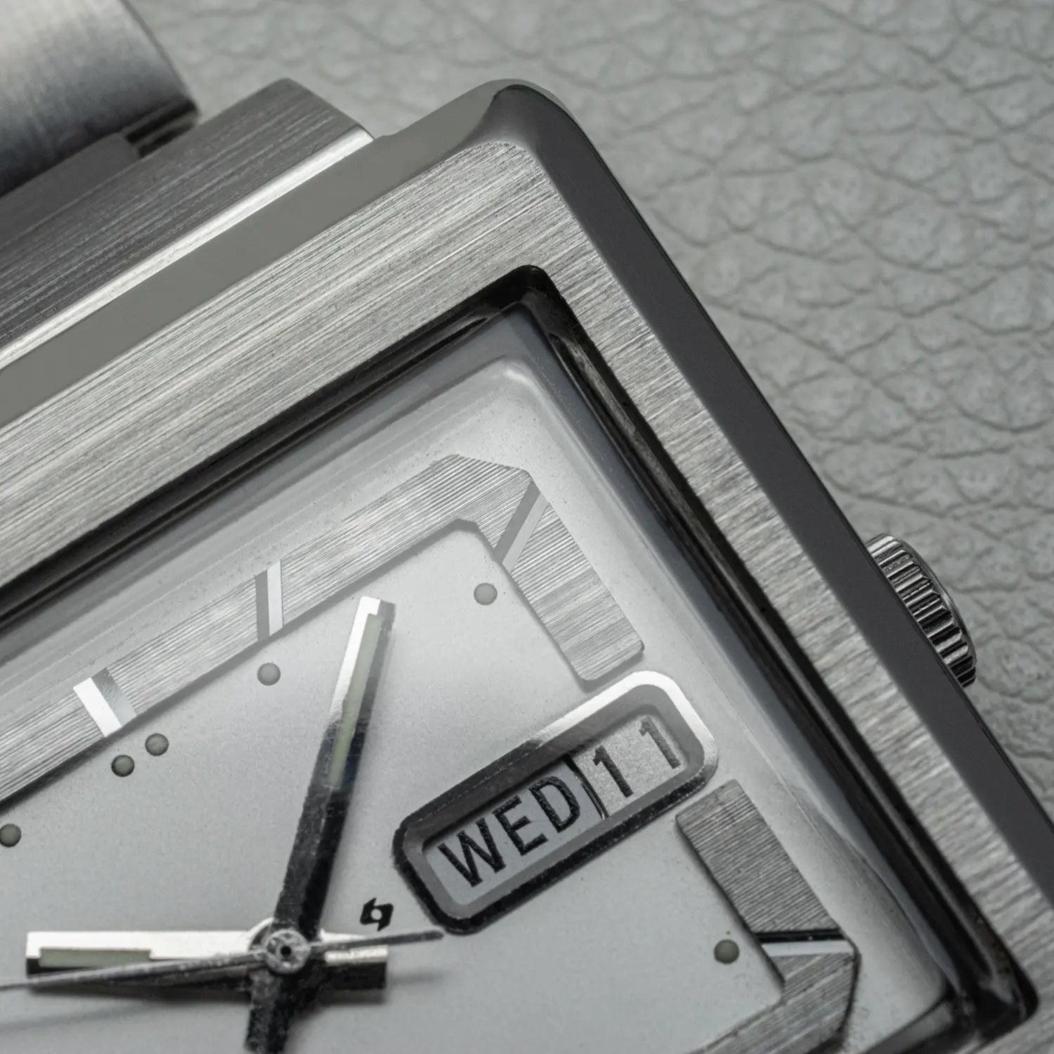 Close-up of a silver Seiko TV Screen Ref. 6309-5030 watch with a textured gray background