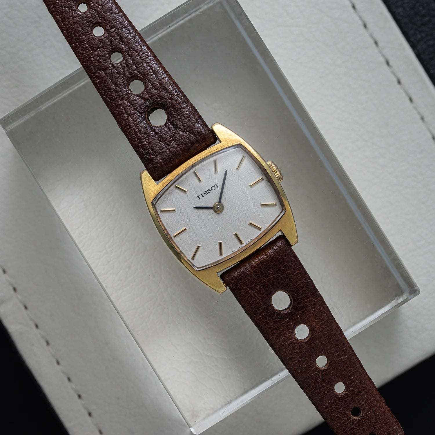 Tissot vintage women’s watch with gold plated case, silver dial, and brown leather strap